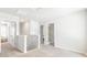 Upstairs hallway showcasing doorways and neutral carpet, with a view of a staircase and multiple rooms at 384 Willows Crescent Dr, Moncks Corner, SC 29461