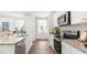 Bright kitchen featuring white cabinets, granite countertops, and stainless steel appliances at 384 Willows Crescent Dr, Moncks Corner, SC 29461