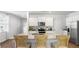 Modern kitchen with a granite island featuring seating, stainless steel appliances, and white cabinetry at 384 Willows Crescent Dr, Moncks Corner, SC 29461
