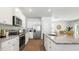 Bright kitchen featuring white cabinets, stainless steel appliances, and an island with granite countertops at 384 Willows Crescent Dr, Moncks Corner, SC 29461