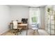 Bright office with a large window, wood desk, rolling chair, and shelving at 384 Willows Crescent Dr, Moncks Corner, SC 29461