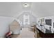 Spacious attic features a tent, writing desk and chair, and a bright window with curtains at 407 Burton Ave, Summerville, SC 29485