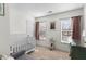 Bright bedroom with a white crib, soft carpet, and natural light from windows with blinds at 407 Burton Ave, Summerville, SC 29485