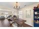 Inviting dining area featuring stylish lighting, hardwood floors, and a seamless connection to the living spaces at 407 Burton Ave, Summerville, SC 29485
