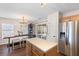 Bright kitchen featuring a large island, stainless steel appliances, and a dining area with a stylish chandelier at 407 Burton Ave, Summerville, SC 29485