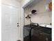 Practical laundry room with modern washer and dryer, shelving, and access to an exterior door at 407 Burton Ave, Summerville, SC 29485