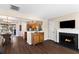 Open-concept living area with fireplace, hardwood floors, seamless flow to dining area, and modern amenities at 407 Burton Ave, Summerville, SC 29485