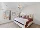 Bright bedroom with a vaulted ceiling, chandelier, a comfortable bed, and natural light from the windows at 407 Burton Ave, Summerville, SC 29485