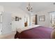 Spacious bedroom featuring a vaulted ceiling, chandelier, and view to the en-suite bathroom at 407 Burton Ave, Summerville, SC 29485