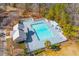 A full community pool is shown in the picture, with buildings nearby and trees all around at 407 Burton Ave, Summerville, SC 29485