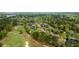 Aerial view of houses surrounded by a golf course and lush trees in a desirable community at 4217 Sawgrass Dr, Charleston, SC 29420