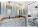 Elegant bathroom featuring double sinks, decorative mirrors, and stylish fixtures at 4217 Sawgrass Dr, Charleston, SC 29420