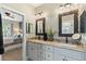 Charming bathroom with dual sinks, decorative mirrors, and views of the bedroom at 4217 Sawgrass Dr, Charleston, SC 29420