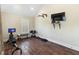 Bright exercise room with wood floors includes workout equipment and a mounted TV at 4217 Sawgrass Dr, Charleston, SC 29420