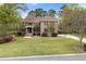 Beautiful brick home with a well-manicured lawn, mature trees, and a welcoming front entrance with double windows at 4217 Sawgrass Dr, Charleston, SC 29420