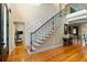 Grand foyer showcasing hardwood floors, staircase with iron railing, and elegant lighting at 4217 Sawgrass Dr, Charleston, SC 29420
