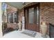 Charming front entrance with a decorative glass door, brick facade, and stylish decor elements at 4217 Sawgrass Dr, Charleston, SC 29420