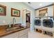 Functional laundry room with modern appliances, a utility sink, and ample storage space at 4217 Sawgrass Dr, Charleston, SC 29420