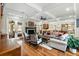 Open-concept living room with fireplace, hardwood floors, and seamless flow into the kitchen and outdoor areas at 4217 Sawgrass Dr, Charleston, SC 29420
