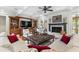 Cozy living room featuring a fireplace, built-in shelving, and comfortable seating with hardwood floors at 4217 Sawgrass Dr, Charleston, SC 29420