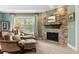 Sitting area in the main bedroom with a stacked stone fireplace at 4217 Sawgrass Dr, Charleston, SC 29420