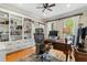 Bright home office with hardwood floors, built-in shelving, and a ceiling fan at 4217 Sawgrass Dr, Charleston, SC 29420