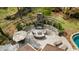 Aerial view of a luxurious outdoor patio with a fireplace, comfortable seating, and a pergola at 4217 Sawgrass Dr, Charleston, SC 29420