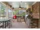 Inviting screened porch with outdoor kitchen, ceiling fan, and comfortable seating area at 4217 Sawgrass Dr, Charleston, SC 29420