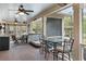 Relaxing screened porch featuring comfortable seating, a hot tub, and a ceiling fan at 4217 Sawgrass Dr, Charleston, SC 29420