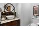 Elegant powder room featuring a vessel sink, marble countertop, and decorative mirror at 4217 Sawgrass Dr, Charleston, SC 29420