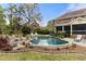 Private swimming pool with rock features and ample patio space for lounging and enjoying the outdoors at 4217 Sawgrass Dr, Charleston, SC 29420