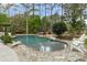 Serene swimming pool with stone edging, lounge chairs, and a tranquil setting for ultimate relaxation at 4217 Sawgrass Dr, Charleston, SC 29420