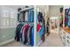 Spacious walk-in closet includes custom storage, shelving, and a window for natural light at 4217 Sawgrass Dr, Charleston, SC 29420