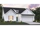 Charming single-Gathering home with white siding, blue door, and a two-car garage at 457 White Magnolia St, Moncks Corner, SC 29461