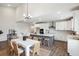 Bright kitchen features an island with seating, stainless appliances, and an adjacent dining area at 457 White Magnolia St, Moncks Corner, SC 29461