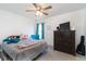 Bedroom features a gray bed with patterned blanket, ceiling fan, and an accent chair at 5007 Ballantine Dr, Summerville, SC 29485
