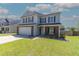 Charming two-story home with a manicured lawn, attached two-car garage, and inviting curb appeal at 5007 Ballantine Dr, Summerville, SC 29485
