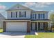 Charming two-story home featuring brick accents, a well-maintained lawn, and an attached two-car garage at 5007 Ballantine Dr, Summerville, SC 29485