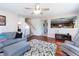 Cozy living room featuring hardwood floors, gray sectional sofa, and seamless flow into other living spaces at 5007 Ballantine Dr, Summerville, SC 29485