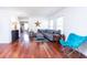 Bright living room featuring hardwood floors, large windows, and a comfortable gray sectional sofa at 5007 Ballantine Dr, Summerville, SC 29485