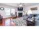 Bright living room featuring a fireplace, gray sectional sofa, and beautiful hardwood floors at 5007 Ballantine Dr, Summerville, SC 29485