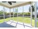 A screened-in porch with a ceiling fan overlooking the green backyard at 5007 Ballantine Dr, Summerville, SC 29485