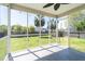 A screened-in porch with a ceiling fan overlooking the green backyard at 5007 Ballantine Dr, Summerville, SC 29485