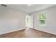 Well-lit bedroom showcasing wood-look floors and direct outdoor access through a glass door at 7027 Deanston Dr, Ravenel, SC 29470
