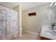 Bathroom featuring a double vanity and a shower with a colorful shower curtain at 708 Professor Dr, Ladson, SC 29456