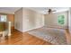 Bright bedroom on the upper level features hardwood floors, ceiling fan, and natural light at 708 Professor Dr, Ladson, SC 29456