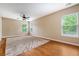 Bright bedroom featuring hardwood floors, ceiling fan, and natural light from multiple windows at 708 Professor Dr, Ladson, SC 29456
