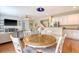 Charming dining area featuring a round table, hardwood floors, and a view of the living room and modern kitchen at 708 Professor Dr, Ladson, SC 29456