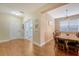 Elegant dining room featuring hardwood floors, a stylish chandelier, and a view into the entryway and office at 708 Professor Dr, Ladson, SC 29456