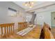 Inviting dining room featuring a solid wood table, bright lighting and a staircase leading to the second floor at 708 Professor Dr, Ladson, SC 29456
